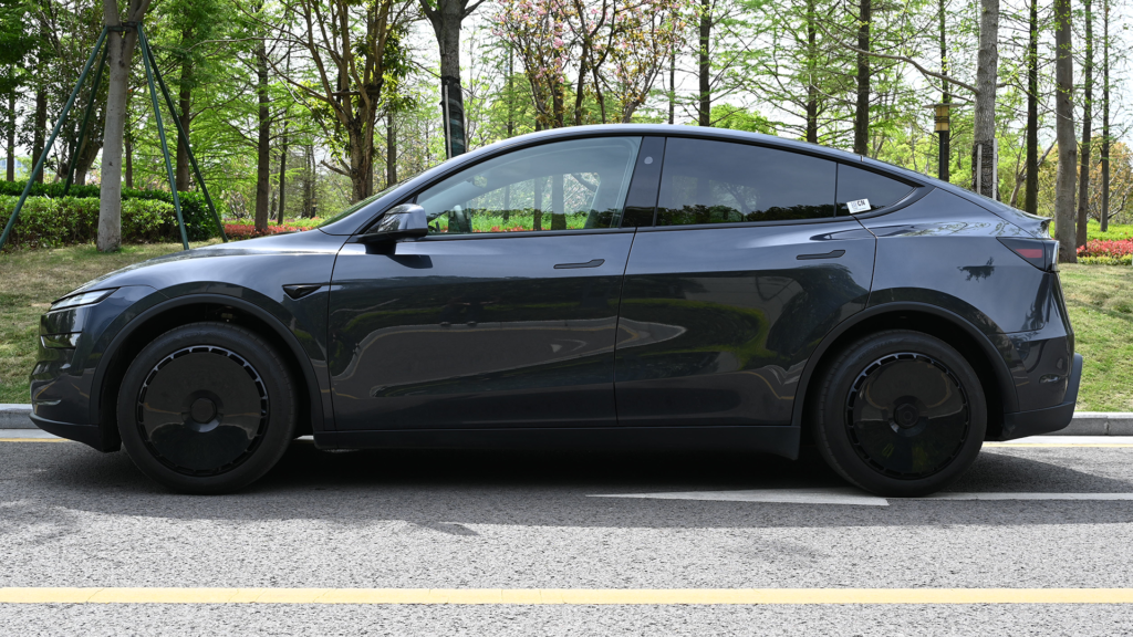 Tesla wheel covers installed on a dark grey Model Y - a warranty-safe upgrade
