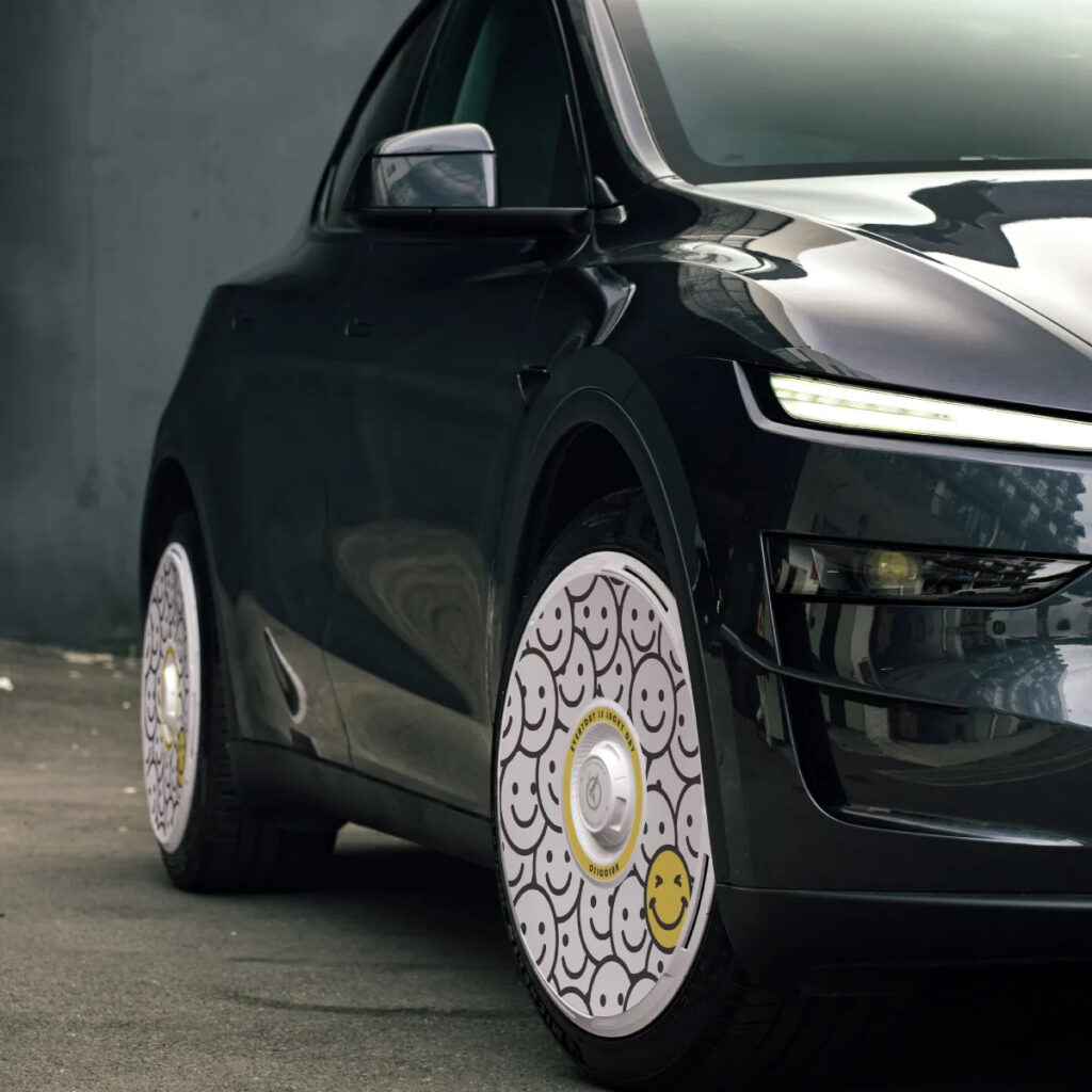 Tesla wheel cover properly seated on a Model Y wheel — secure clip engagement stops covers from falling off