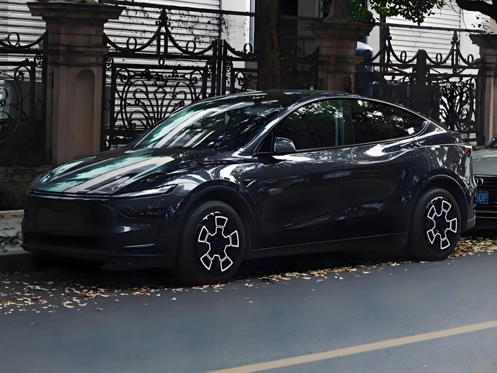 Tesla wheel cover replacement on a dark Model Y parked at the curb