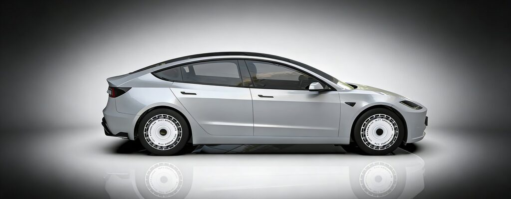 Silver Tesla Model 3 with full-face wheel covers, side profile view