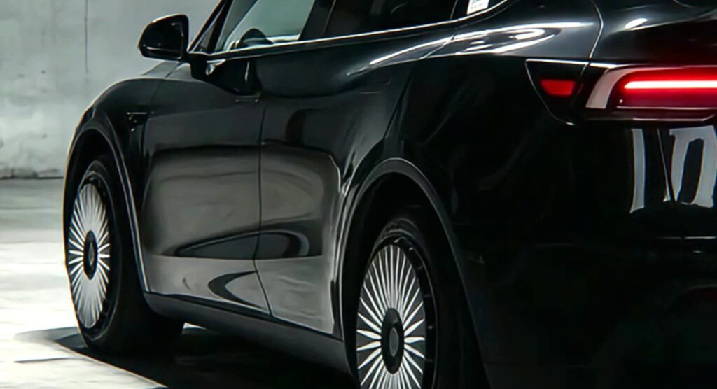 Tesla wheel covers on a black Model Y parked for long-term storage