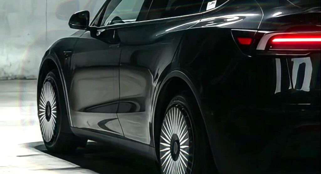 Black Tesla Model Y wearing white radial turbine wheel covers, safe at highway speeds